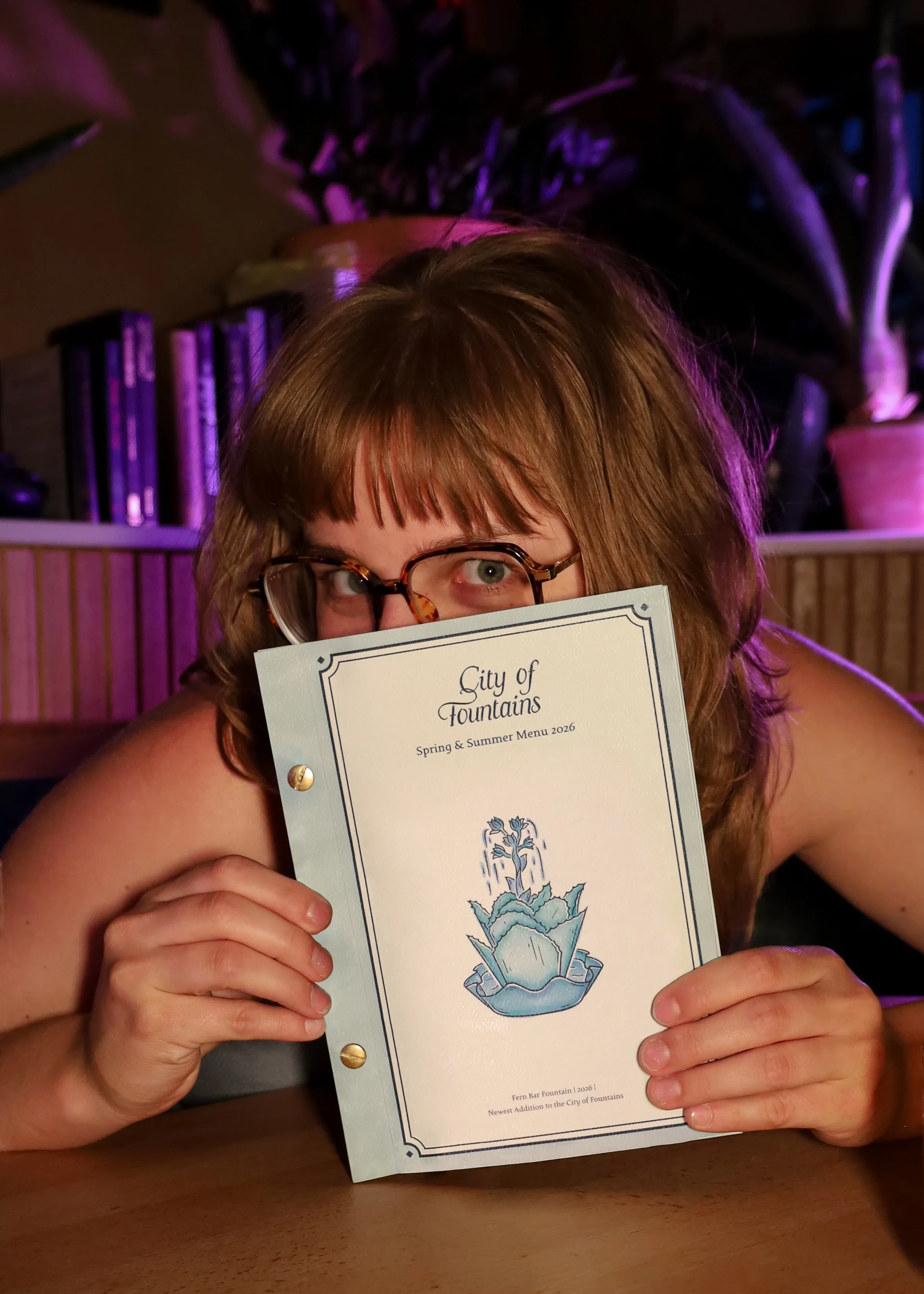 Claire Henry holding City of Fountains menu